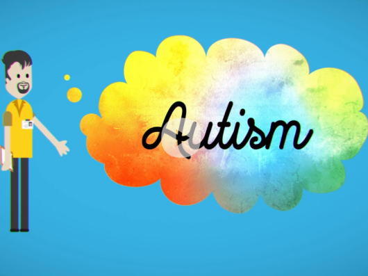 Animated figure standing next to colourful speech bubble which contains the word: autism.