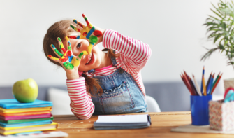 Preschool child with paint on hands