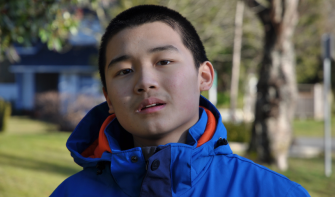 Late teens boy looking into camera