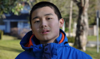 Late teens boy looking into camera 