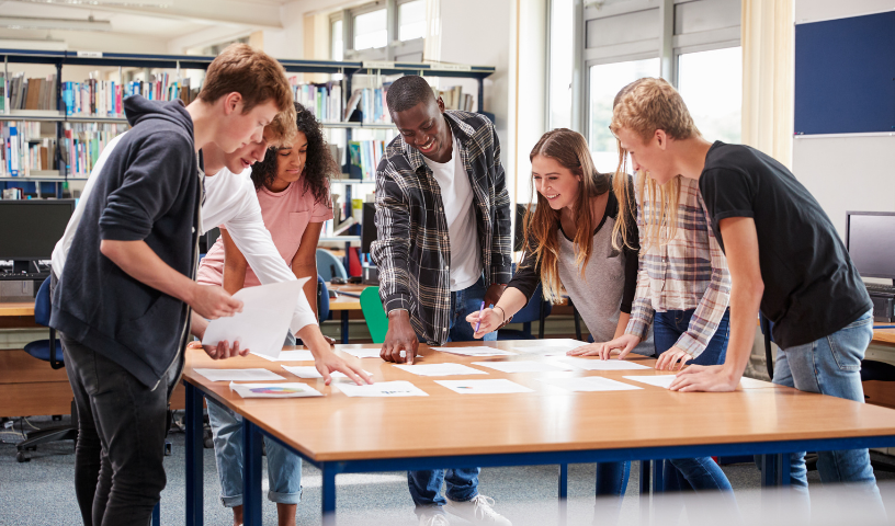 College students working together around table in classroom