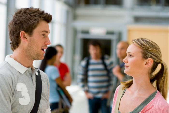 Two students talking in hallway