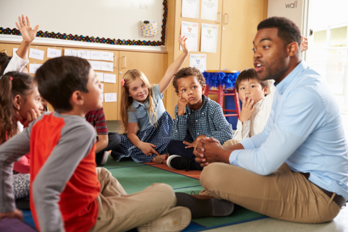 Teacher with kids on the floor